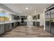 Well-lit kitchen with gray cabinets, double oven, quartz countertop, and stainless steel appliances at 2679 Haines Bayshore Rd, Clearwater, FL 33760