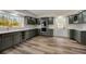 Modern kitchen with gray cabinets, stainless steel appliances, including a wine cooler, and ample counter space at 2679 Haines Bayshore Rd, Clearwater, FL 33760