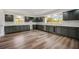 Bright kitchen boasts sleek gray cabinets, stainless steel appliances, wine cooler, and light countertops at 2679 Haines Bayshore Rd, Clearwater, FL 33760