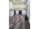 Well-lit laundry room with modern appliances, cabinetry, and stylish flooring at 2679 Haines Bayshore Rd, Clearwater, FL 33760