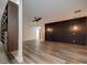 Spacious living room with modern flooring, ceiling fan, and stylish dark wood accent wall at 2679 Haines Bayshore Rd, Clearwater, FL 33760