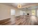 Spacious living room featuring modern flooring, an elegant fireplace, and abundant natural light from large windows at 2679 Haines Bayshore Rd, Clearwater, FL 33760