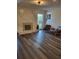 Cozy living room with a decorative fireplace, hardwood floors, and comfortable seating area, perfect for relaxation at 2679 Haines Bayshore Rd, Clearwater, FL 33760
