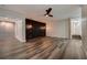 Bright living room features new flooring, modern lighting, and a stylish accent wall at 2679 Haines Bayshore Rd, Clearwater, FL 33760