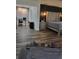 Bedroom with modern flooring, stylish lighting, and an adjacent office area for convenience at 2679 Haines Bayshore Rd, Clearwater, FL 33760