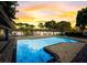 Beautiful pool area with a large pool and a tranquil setting at sunset at 2679 Haines Bayshore Rd, Clearwater, FL 33760
