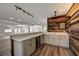 Beautiful wet bar with quartz countertops, grey cabinets, built in wine cooler and wood paneling at 2679 Haines Bayshore Rd, Clearwater, FL 33760