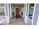 Charming front porch with a red door and decorative windows, creating a welcoming entrance to the home at 2797 Cordova S Way, St Petersburg, FL 33713