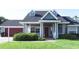 Charming home featuring a red garage door, dormer windows, a well-maintained lawn, and a welcoming front porch at 2797 Cordova S Way, St Petersburg, FL 33713