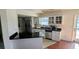 Bright kitchen featuring white cabinets, granite countertops, stainless steel appliances and a breakfast bar at 2797 Cordova S Way, St Petersburg, FL 33713