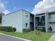 Exterior of a two-story apartment building with nice landscaping and blue sky and clouds above at 2868 Somerset Park Dr # 103, Tampa, FL 33613
