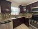 View of the recently updated kitchen with stainless appliances, granite countertops, and wooden cabinets at 2868 Somerset Park Dr # 103, Tampa, FL 33613