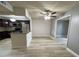 Open concept living and dining space with wood look floors and bar top looking into the kitchen at 2868 Somerset Park Dr # 103, Tampa, FL 33613