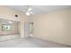 This bedroom features neutral walls, mirrored closet doors, and a ceiling fan at 3066 Landmark Blvd # 1305, Palm Harbor, FL 34684