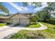 Charming home exterior with a two-car garage, well-maintained landscaping, and a walkway at 3066 Landmark Blvd # 1305, Palm Harbor, FL 34684