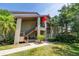 Exterior of a multi-story home with a stairway entrance, landscaping, and mature trees at 3066 Landmark Blvd # 1305, Palm Harbor, FL 34684