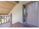 Exterior of the front door and porch with brick pavers and a security screen at 3066 Landmark Blvd # 1305, Palm Harbor, FL 34684