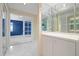 Hallway with large storage and pass-through to a bright blue room at 3066 Landmark Blvd # 1305, Palm Harbor, FL 34684