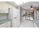 Bright kitchen featuring tile flooring, white appliances, and ample cabinet space at 3066 Landmark Blvd # 1305, Palm Harbor, FL 34684