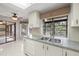 Charming kitchen features double sink and great natural light from the backyard at 3066 Landmark Blvd # 1305, Palm Harbor, FL 34684