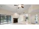 Bright living room with fireplace and sliding glass doors to deck with a ceiling fan and ample natural light at 3066 Landmark Blvd # 1305, Palm Harbor, FL 34684