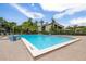 Enjoy the large community pool, surrounded by lush landscaping, with ample lounge chairs for relaxing at 3066 Landmark Blvd # 1305, Palm Harbor, FL 34684