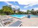 This large pool has lounge chairs and side tables, providing the perfect place to relax and enjoy the community at 3066 Landmark Blvd # 1305, Palm Harbor, FL 34684