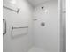 Close up of the bright walk-in shower with white tile and silver fixtures at 3066 Landmark Blvd # 1305, Palm Harbor, FL 34684