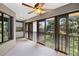 This bright sunroom features floor-to-ceiling windows and a ceiling fan, perfect for enjoying the outdoors from inside at 3066 Landmark Blvd # 1305, Palm Harbor, FL 34684