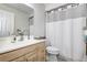 Bathroom featuring a wooden vanity, a shower with a decorative curtain, and ample lighting at 3122 37Th S Ln # C, St Petersburg, FL 33711