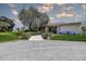 Exterior view of the clubhouse, set back from the road with manicured bushes at 3122 37Th S Ln # C, St Petersburg, FL 33711