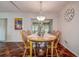 Charming dining area with wooden table, chandelier lighting, and a large window view at 3122 37Th S Ln # C, St Petersburg, FL 33711
