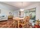Inviting dining room next to the living room, featuring sliding glass doors and a chandelier at 3122 37Th S Ln # C, St Petersburg, FL 33711