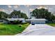 Charming single-story home with a three-car garage, lush lawn, and well-maintained landscaping at 3122 37Th S Ln # C, St Petersburg, FL 33711