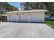 Exterior shot of detached garages with white doors at 3122 37Th S Ln # C, St Petersburg, FL 33711