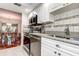 Bright kitchen with stainless steel appliances and granite countertops that adjoins the dining room at 3122 37Th S Ln # C, St Petersburg, FL 33711