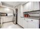 Spacious kitchen with stainless steel refrigerator, white cabinets, and stylish backsplash at 3122 37Th S Ln # C, St Petersburg, FL 33711