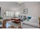 Bright living room featuring comfortable seating, hardwood floors, and a window at 3122 37Th S Ln # C, St Petersburg, FL 33711
