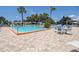 Community pool and surrounding patio with lounge seating and tables at 3122 37Th S Ln # C, St Petersburg, FL 33711