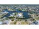 Scenic aerial view showcasing the waterfront property, neighborhood, and canal systems at 3174 Sanibel Dr, Hernando Beach, FL 34607