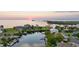 Stunning aerial view of waterfront home with private dock and beautiful sunset backdrop at 3174 Sanibel Dr, Hernando Beach, FL 34607