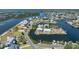 Expansive aerial view showcasing the waterfront property with a private pool and boat dock at 3174 Sanibel Dr, Hernando Beach, FL 34607