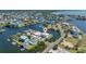 Overhead shot featuring waterfront property, boat docks, lush surroundings, and neighborhood at 3174 Sanibel Dr, Hernando Beach, FL 34607