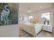 Bright bedroom with large windows, ceiling fan, and stylish heron artwork at 3174 Sanibel Dr, Hernando Beach, FL 34607