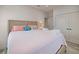 Cozy bedroom featuring soft bedding, pastel accents, and ample closet space at 3174 Sanibel Dr, Hernando Beach, FL 34607