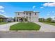 Beautiful two-story home with a lush green lawn and spacious driveway at 3174 Sanibel Dr, Hernando Beach, FL 34607