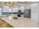 Close up of kitchen with white cabinets, quartz countertops, stainless appliances and pendant lighting at 3174 Sanibel Dr, Hernando Beach, FL 34607