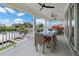 Inviting outdoor porch with water views featuring modern ceiling fans and comfortable seating arrangement at 3174 Sanibel Dr, Hernando Beach, FL 34607