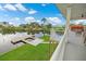 Covered porch showcases waterfront views and direct access to private dock and lush landscaping at 3174 Sanibel Dr, Hernando Beach, FL 34607