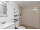 Bright bathroom featuring a shower, toilet, and vanity with mirror and built-in storage cabinet at 3455 Countryside Blvd # 31, Clearwater, FL 33761
